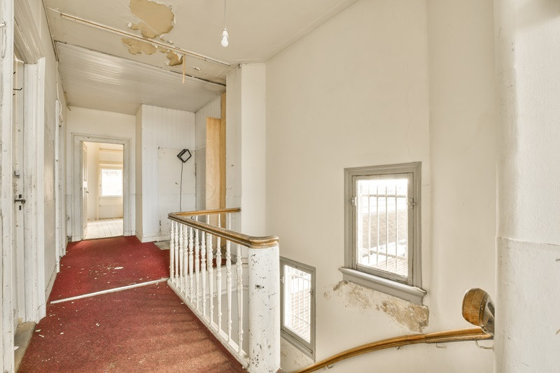 the upstairs hallway of an old house with a staircase SMART Environmental Services Kansas City Lead Removal AdobeStock_600231754
