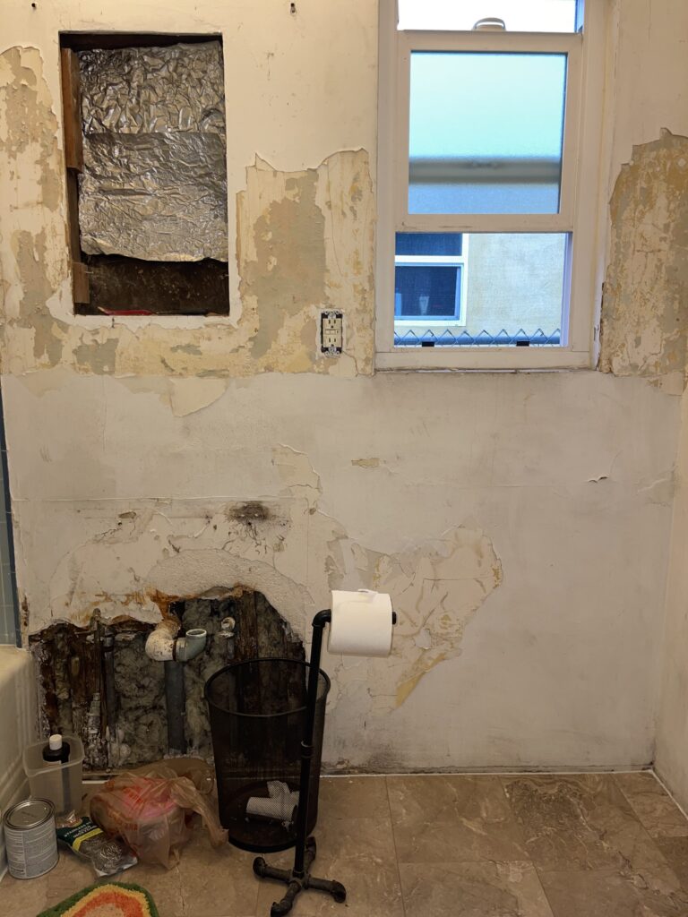 Asbestos Remediation of bathroom with removed drywall